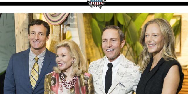 Four people stand smiling at a San Francisco event. Behind them is colorful decor. At the top, the San Francisco Examiner logo features bold text and an eagle emblem. The group includes two men in suits and two women in elegant outfits, all attending the San Francisco Fall Show 2024.